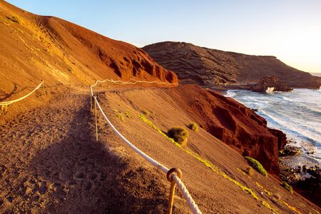 Footpath to El Golfo bay on the sunset on Lanzarote island in Spainの写真素材