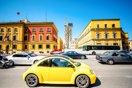 TIRANA, ALBANIA CIRCA JUNE 2015: Crowded by cars street with old buildings and new skyscraper on the...