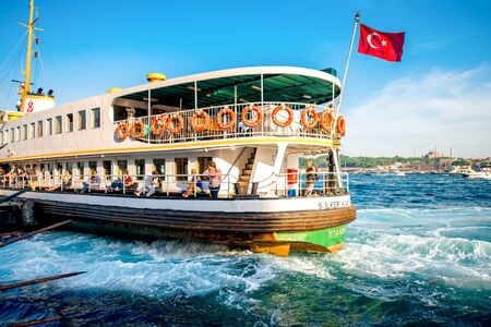 ISTANBUL - MAY 28, 2015: Ferry full with tourists floats on Bosphorus waterway in Istanbul on the sunset. Ferry in Istanbul is very popular transportation between European and Asian part of the cityのeditorial素材