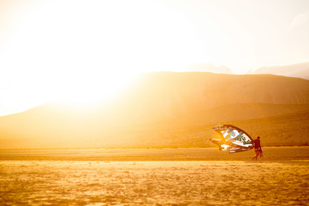 JANDIA, FUERTEVENTURA ISLAND, SPAIN - SIRCA JANUARY 2016: Windsurfer walks after the training on...
