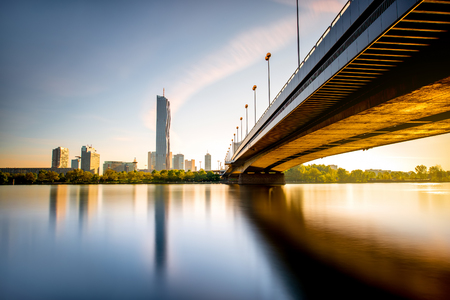 View on Donaucity with bridge in Vienna in the morning. Wide angle image with long exposure technic with glossy water and reflectionの写真素材