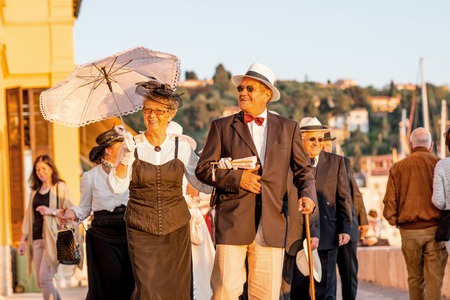 Piran, Slovenia - May 8, 2016: Elder couple in traditional slovenian costumes walk during Tartini Festival in Piran. The Tartini Festival is an music festival dedicated to maestro Giuseppe Tartini.のeditorial素材