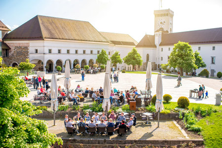 Ljubljana, Slovenia - May 6, 2016: Internal yard of Ljubljana castle crowded with people sit at the restaurant terrace. This castle now is popular place for weddings and cultural eventsのeditorial素材