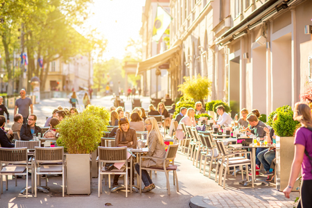 Ljubljana, Slovenia - May 6, 2016: People sit at the cafe in the old city centre in Ljubljana. Ljubljana is the capital of Slovenia and famous european tourist destination.のeditorial素材