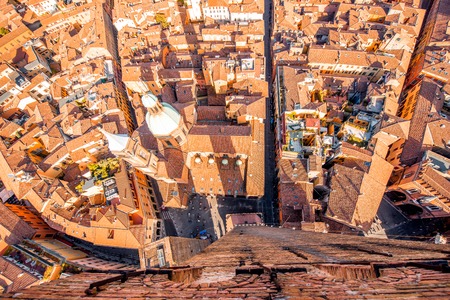 Aerial cityscape view from the tower on Bologna old town with Garisenda tower and roman catholic churchの写真素材