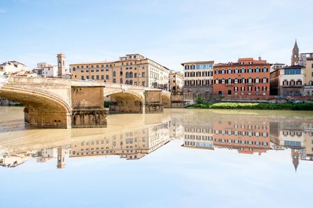 Cityscape view on the riverside with the old buildings and palaces near Holy Trinity bridge in Florenceの写真素材