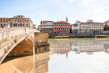 Cityscape view on the riverside with the old buildings and palaces near Holy Trinity bridge in Florenceの写真素材