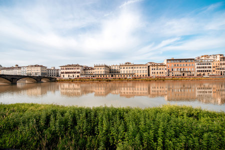 Cityscape view on the riverside with the old buildings and palaces near Holy Trinity bridge in Florenceの写真素材