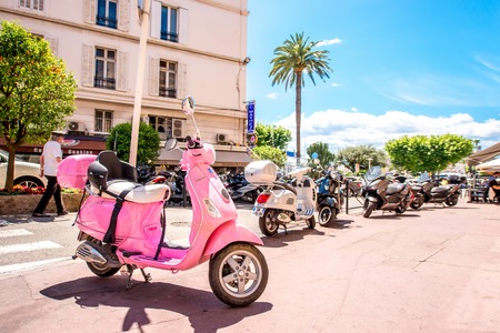 Cannes, France - June 14, 2016: Pink scooter on the street in Cannes city on the French riviera.のeditorial素材