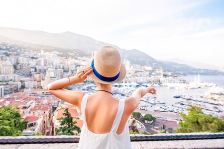 Young female traveler enjoying great view on the city with harbor in Monte Carlo in Monacoの写真素材