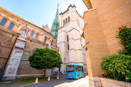 Geneva, Switzerland - June 23, 2016: Saint Pierre church and blue public bus in the old town of...