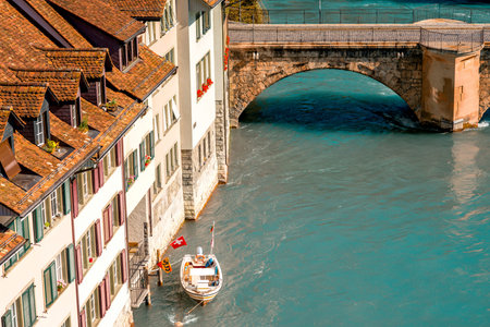 Cityscape view on the riverside with boat and bridge in the old town of Bern city in Switzerlandの写真素材