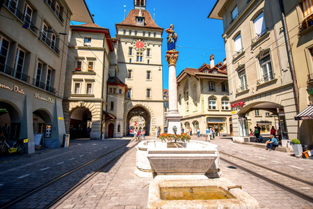 Bern, Switzerland - June 24, 2016: Street view with medieval tower and old city gate on Markt street...
