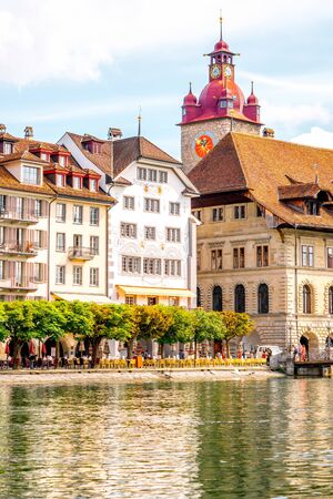 View on the riverside with beautiful buildings and town hall taower in Lucerne old town in Switzerlandの写真素材