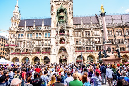 Munich, Germany - July 03, 2016: Tourists looking at the dolls performance on the main clock Glockenspiel of the town hall in Munich. This is very popular tourist attraction in Bavariaのeditorial素材