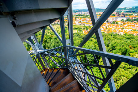 Metal stairs in Petrin tower with the view on the old town in Prague