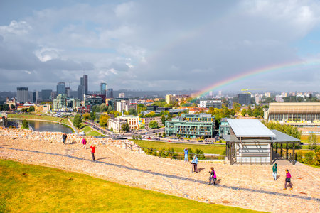 Vilnius, Lithuania - September 21, 2016: Cityscape view on the financial distict from the castle hill during the cloudy weather with rainbow in the sky.のeditorial素材
