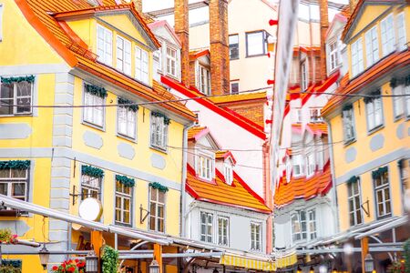 Beautiful buildings with reflection on Livu square in the old town of Riga, Latvia.の写真素材