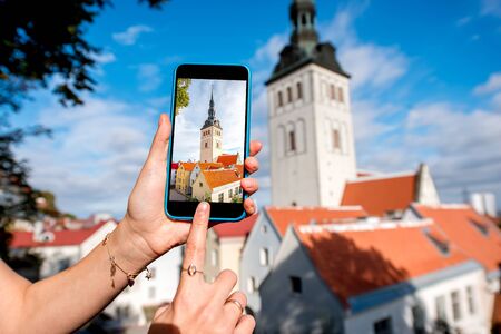 Photographing with smart phone saint Nicholas church in the old town in Tallinn, Estoniaの写真素材