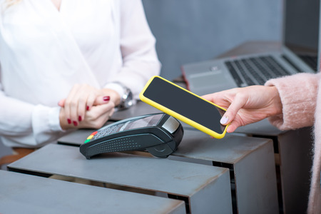 Contactless payment with mobile phone and banking terminal in the storeの写真素材