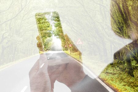 Holding phone on the nature backgroundの写真素材