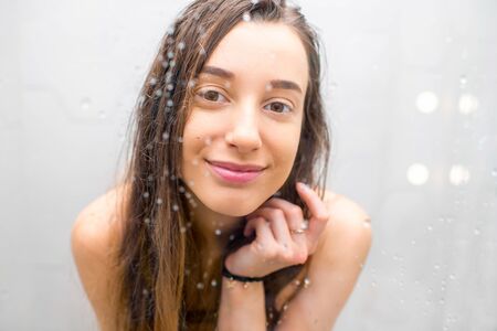 Young woman showeringの写真素材