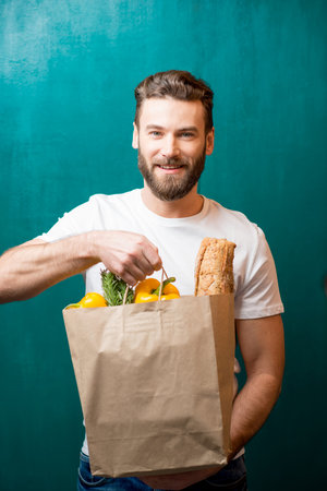 Man with bag full of foodの写真素材