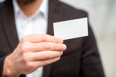 Man showing business cardの写真素材