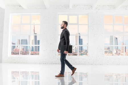 Businessman in the white office interiorの写真素材