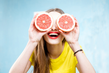 Colorful portrait of a woman with flower wreath and fruitsの写真素材