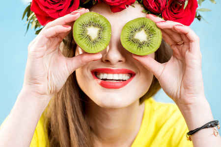 Colorful portrait of a woman with flower wreath and fruitsの写真素材