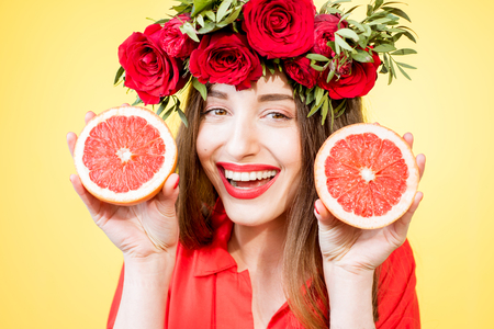 Colorful portrait of a woman with flower wreath and fruitsの写真素材