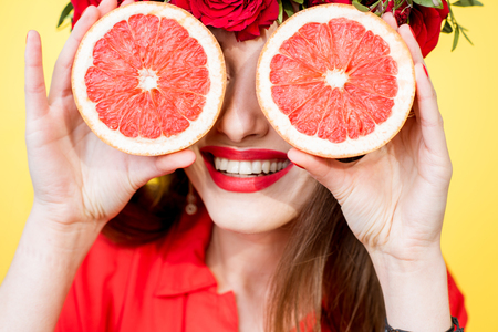 Colorful portrait of a woman with flower wreath and fruitsの写真素材