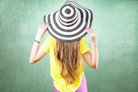 Colorful portrait of a young woman in hatの写真素材
