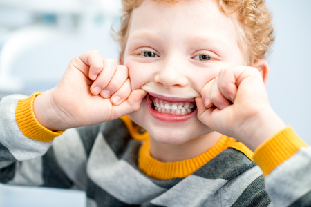 Portrait of a smiling boy at the dental officeの写真素材