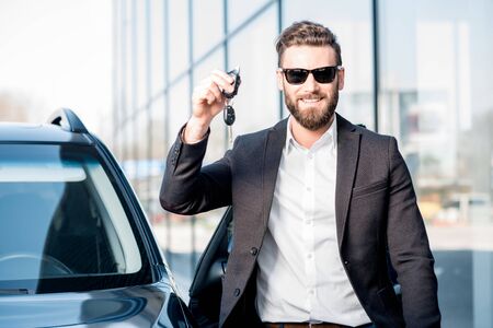 Man with keys near the carの写真素材