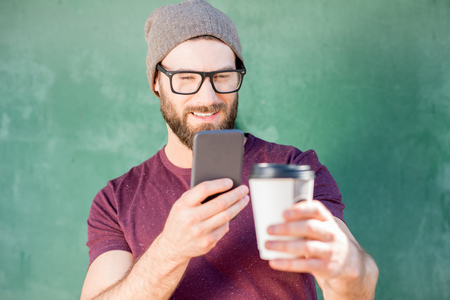 Man with coffee on the green backgroundの写真素材