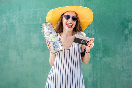 Woman holding a jar full of money for summer vacation
