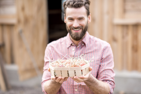 Farmer with hen eggsの写真素材