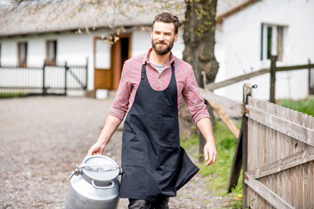 Farmer with milk outdoors