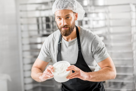 Cheese maker at the manufacturingの写真素材