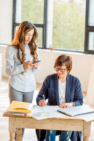 Businesswomen working together indoorsの写真素材