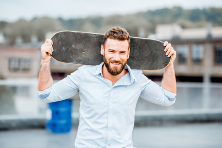 Businessman portrait with skateboardの写真素材