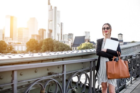 Businesswoman with laptop outdoorsの写真素材