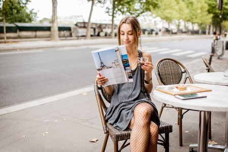 Elegant woman sitting at the french cafeの写真素材