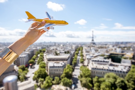 Toy airplane on the Paris cityscape backgroundの写真素材
