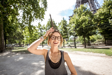 Woman with toy Eiffel towerの写真素材