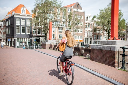 Woman with bicycle in Amsterdam cityの写真素材