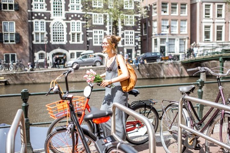 Woman with bicycle in Amsterdam cityの写真素材