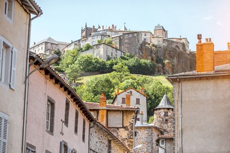 View on the old buildings and hill with fortress in saint Flour village in Auvergne region, Franceの写真素材